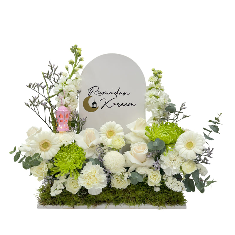 A floral display with white and green flowers, a