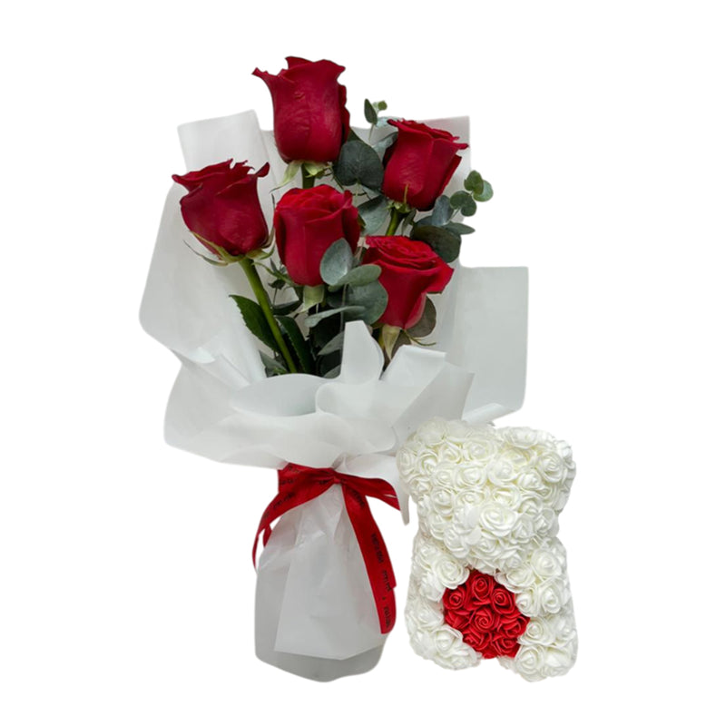 A bouquet of red roses with a white rose teddy arrangement for Valentine’s Day.