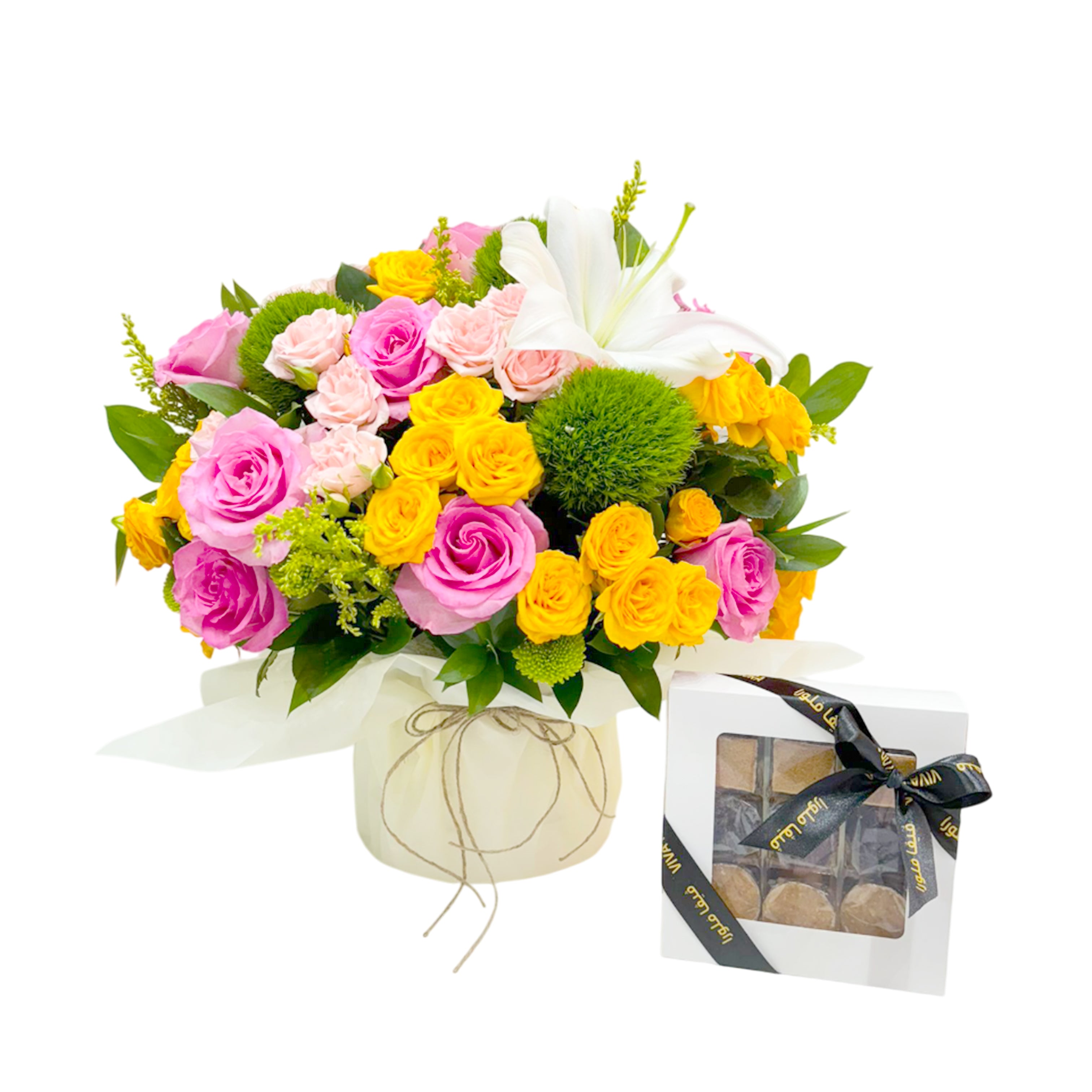 Vibrant bouquet of pink, yellow, and peach roses with lilies and greenery next to a white gift box of assorted chocolates tied with a black Viva Flora ribbon.