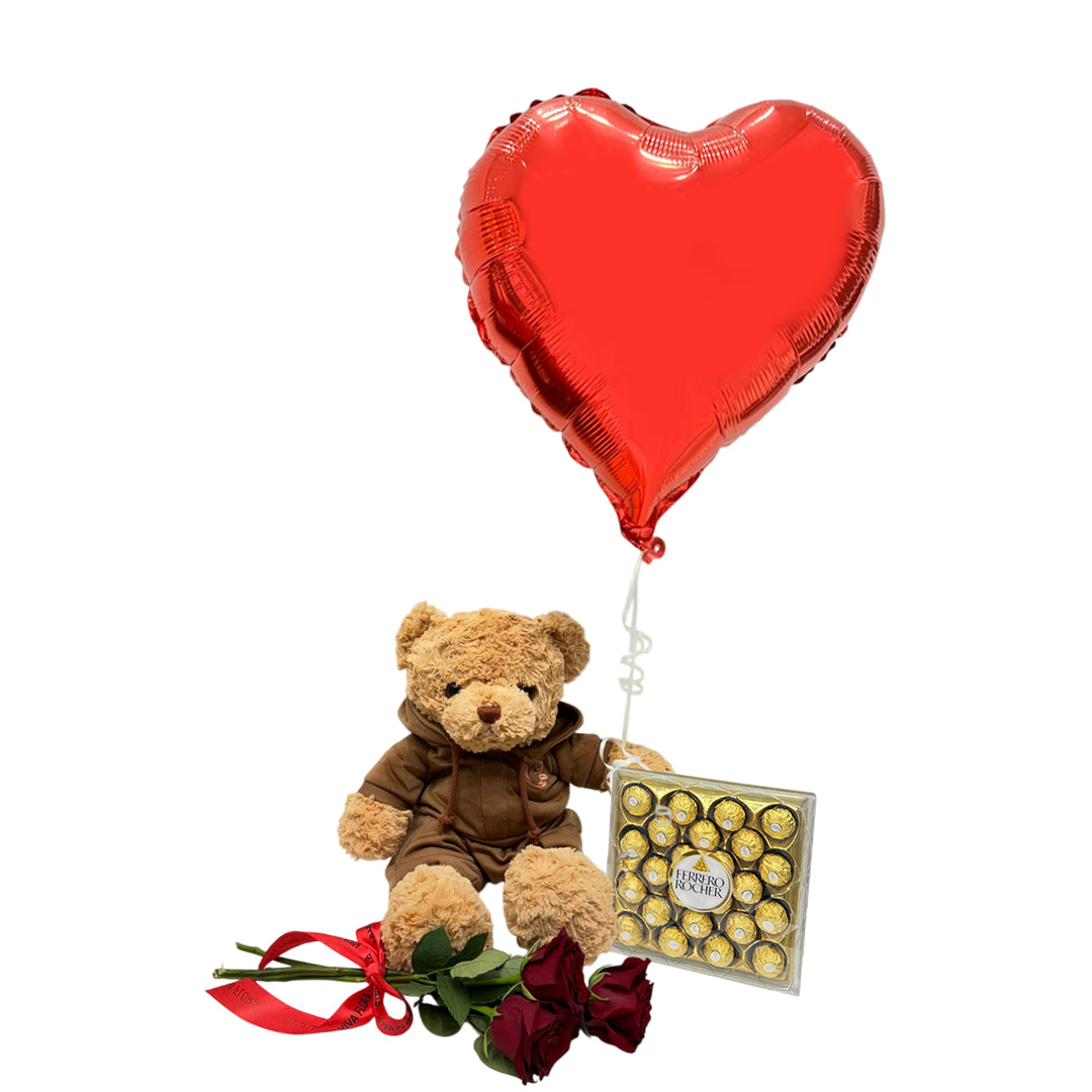 Romantic gift set with a teddy bear, heart-shaped balloon, red roses, and chocolates for Valentine’s Day