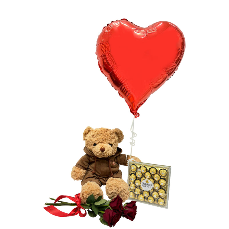Romantic gift set with a teddy bear, heart-shaped balloon, red roses, and chocolates for Valentine’s Day