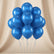 10 blue balloons tied with curly blue strings, arranged in a cluster against a plain light beige background.