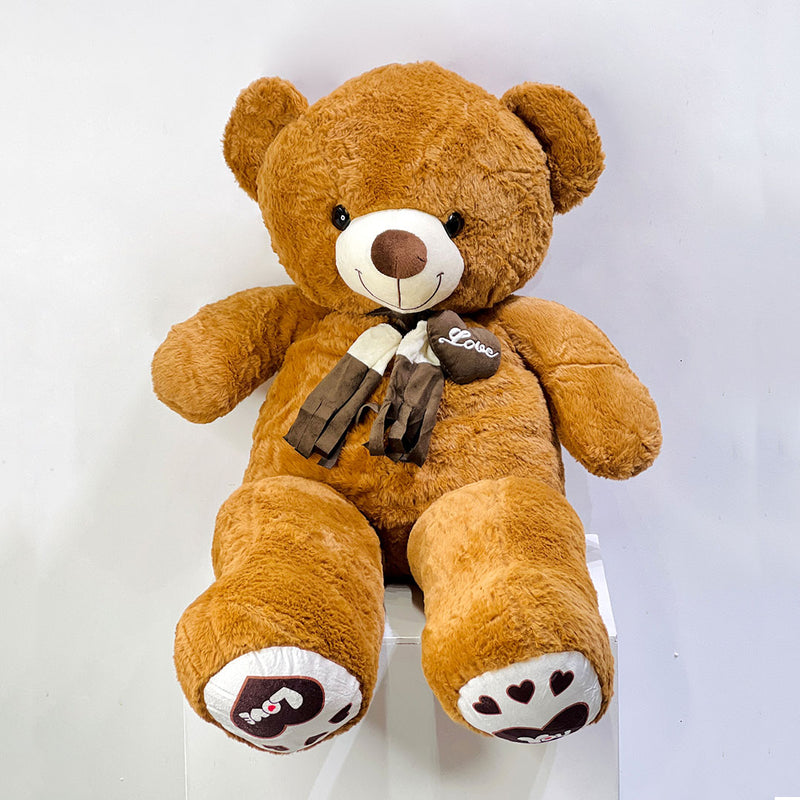 high quality Brown teddy bear with a bow tie on a white background send to your loved once in Qatar same day delivery available all over qatar. 