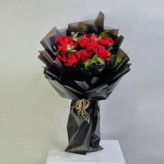featuring new viva flora 2026 valentine Bouquet of red roses wrapped in black paper on a white platform with a light gray background