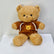 Brown teddy bear wearing a hoodie with a smiley face place the order now for same day delivery in qatar