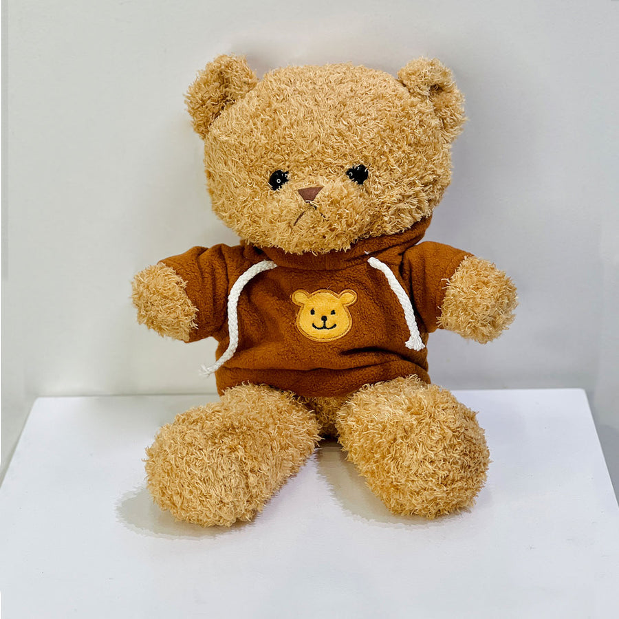 Brown teddy bear wearing a hoodie with a smiley face place the order now for same day delivery in qatar