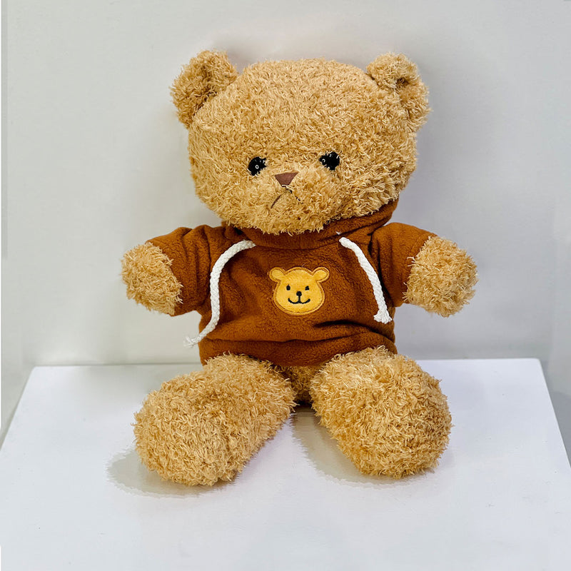 Brown teddy bear wearing a hoodie with a smiley face place the order now for same day delivery in qatar