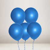 Five blue balloons tied with curly blue strings, arranged in a cluster against a plain light beige background.