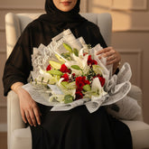 Bouquet of red and white flowers wrapped in newspaper on QATARI WOMAN LAP 