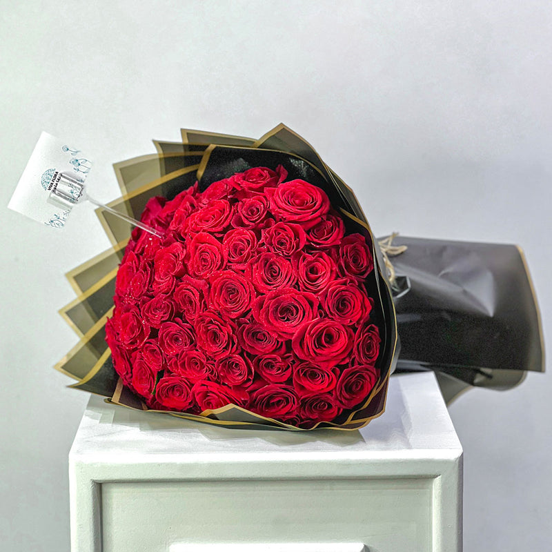 Bouquet of red roses wrapped in black paper perfect for birthday, anniversary and valentine 