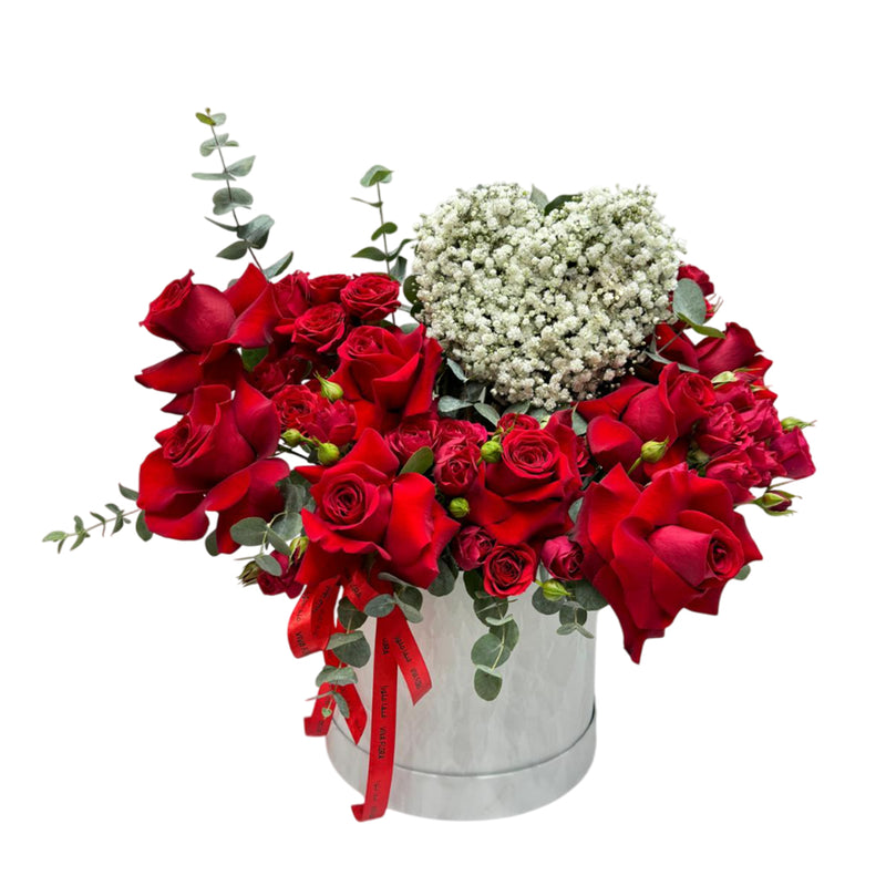 Red rose arrangement in a box with an  heart-shaped filled with baby's breath