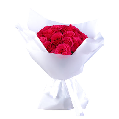 Bouquet of fresh pink roses, elegantly wrapped in white paper, ideal for romantic occasions and heartfelt expressions of love.