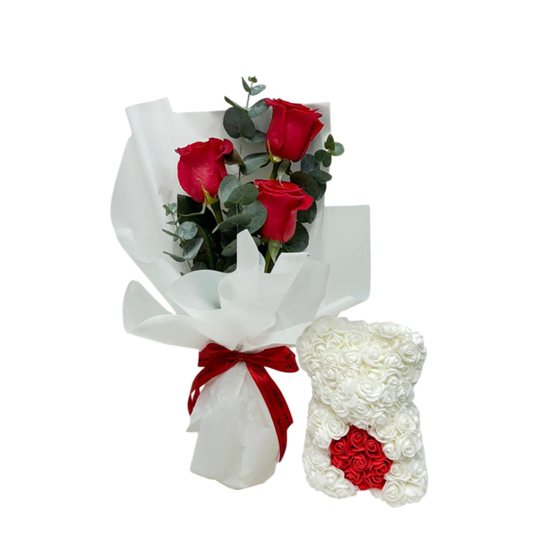 A bouquet of red roses with a white rose teddy arrangement for Valentine’s Day.