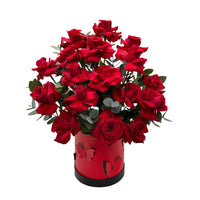 A red box accented with butterflies filled witth red roses and eucalyptus.