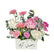 A white Ramadan Kareem gift box filled with pink and white roses, gerberas, lisianthus, and a silver lantern, creating an elegant Eid floral arrangement.