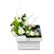 White floral gift box with peach-toned roses, gerberas, and 800g of assorted chocolates, tied with black ribbon—presented in a Viva Flora tray.