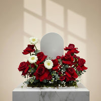 Flower arrangement with red roses, white gerberas