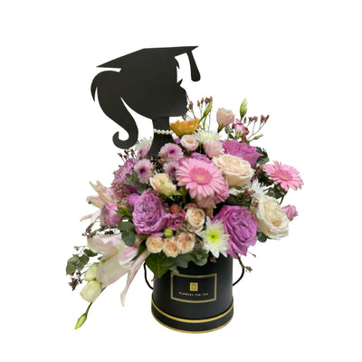 Gradution Black gift box filled with pink, white, and purple mixed flowers, decorated with a silhouette of a female graduate wearing a cap.