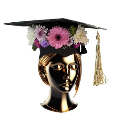  Woman in a black abaya wearing a graduation cap decorated with fresh white and pink flowers