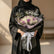 A bouquet of white and light purple roses wrapped in black paper with a light purple inner liner and a white ribbon bow, featuring a silver Arabic nameplate topper.