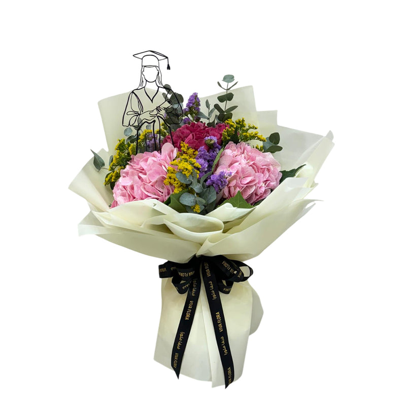 Mixed flower graduation bouquet wih a lady graduation topper.