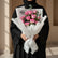 A bouquet of pink roses wrapped in white tissue paper with a white ribbon and printed card that reads 'best MOM ever,' displayed on a white pedestal against a warm beige background.