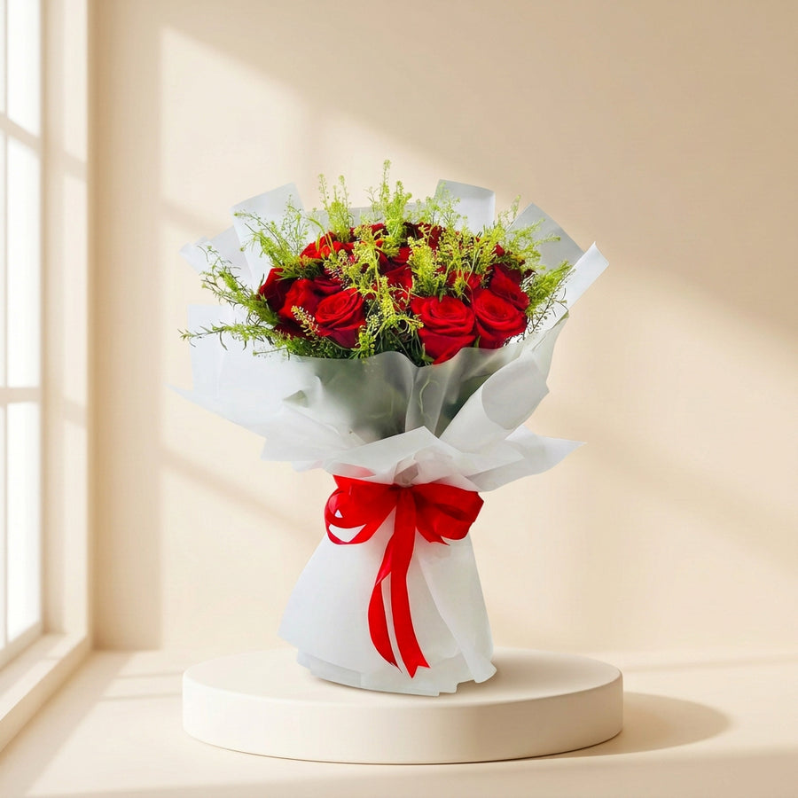 perfect hand bouquet with red roses and transparent wrapping in beige colour background  