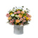 A pastel dream box of roses, gerberas, and daisies in a white box.