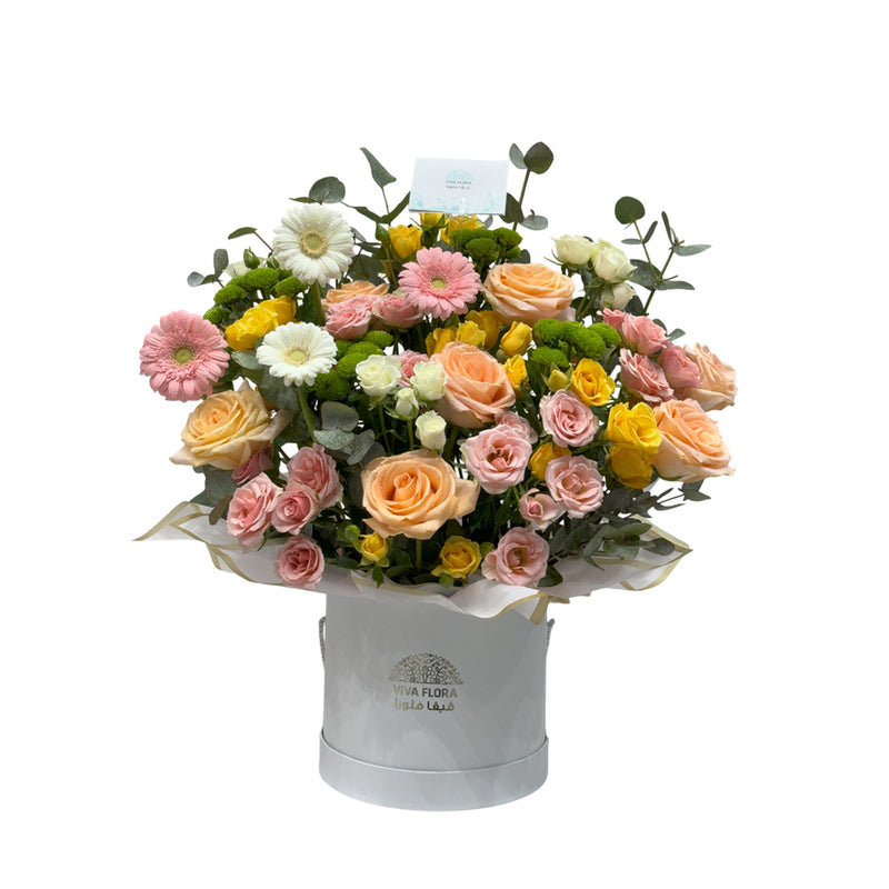 A pastel dream box of roses, gerberas, and daisies in a white box.