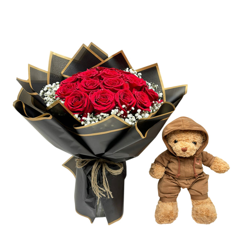 Red rose bouquet with red roses and gypso in a black wrap with a cuddly teddy.