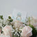 Blush and white roses bouquet wrapped in black paper with baby’s breath