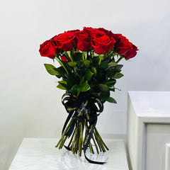 European style Bouquet of red roses with a black ribbon on a white surface. fnp.qa , Floward.qa , Arabianflorist.qa