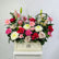 A vibrant floral arrangement in a cream-colored rectangular box on a white pedestal, featuring pink, red, white, and green flowers with a gold 'Happy Birthday' sign, from the brand VIVA FLORA.
