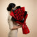 A large bouquet of red roses wrapped in bright red and black paper, held by a person's arm on the left. The bouquet is tied with a red ribbon printed with 'Viva Flora'.