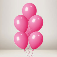 Five glossy pink balloons clustered together with thin pink strings, photographed against a soft light gray studio background.