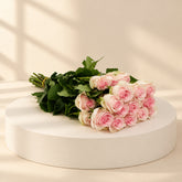 bunch of pink roses in a podium