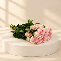 bunch of pink roses in a podium
