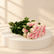 bunch of pink roses in a podium