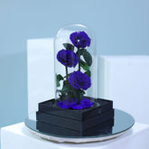 Elegant arrangement of three blue preserved roses in luxury wrapping for gifting in Qatar