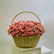 Basket filled with soft pink spray roses arranged in a rounded floral display